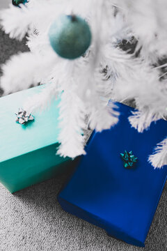 Christmas Tree With White Frosted Snow Style And Blue And Teal Toned Presents And Baubles