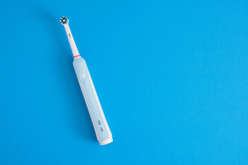 electric blue toothbrush on bright geometric pink background oral hygiene concept copy space