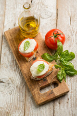 Caprese salad traditional italian recipe with mozzarella tomato basil and bread