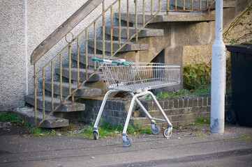 Shopping trolley abandoned on street at council estate