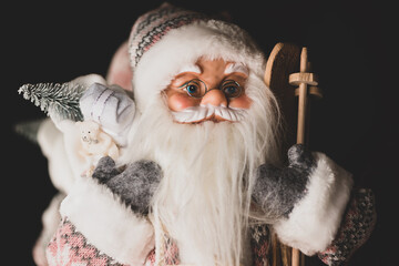 Close-up of santa claus doll, santa claus statue with christmas decorations and gifts. Winter holidays concept
