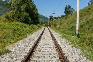 Fototapeta na wymiar Circum-Baikal Railway. Railroad in front of the Station Angasolskaya. Lake Baikal, Russia