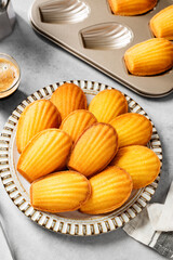 Perfect French madeleine cookies, buttery and delicate, served with cup of coffee. Light gray  background. 