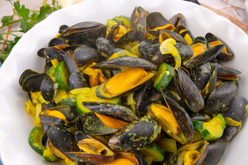 delicious cooked mussels with zucchini in white plate