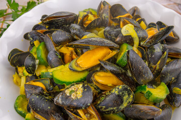 delicious cooked mussels with zucchini in white plate