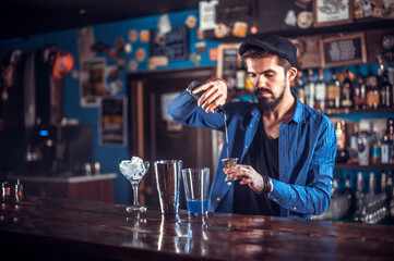 Bartender makes a cocktail on the bar