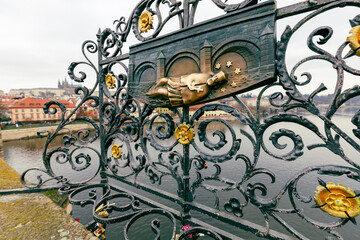 Fototapeta na wymiar An old relief below the statue of St. John of Nepomuk on Charles Bridge in Prague, Czech Republic. According to legend good luck and a promise of return trip to Prague comes to those who touch it.