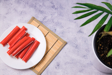 Crab sticks surimi on a plate. Top view, flat-lay