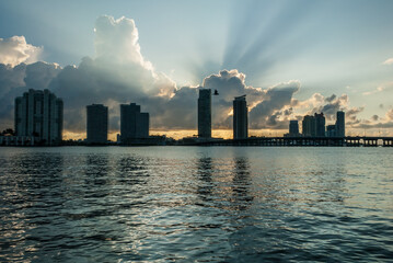 Miami Beach, Florida cityscape at sunset with intracoastal waterway in the foreground. Captured from Star Island