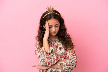 Little caucasian princess with crown isolated on pink background with headache