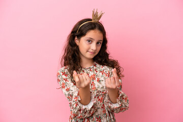 Little caucasian princess with crown isolated on pink background making money gesture