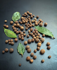 Dried berries of the allspice on the dark background. Close-up.
