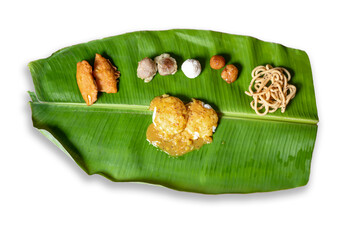 Traditional dish served on banana leaf on Indian festival day. It is served breakfast on festival of Diwali. idli sambar, sweet and Alkali.