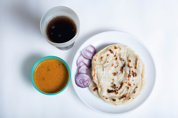 Kerala parotta with chicken curry and coke (cool drinks ) isolated on a white background. is a delicacy from the state of Kerala