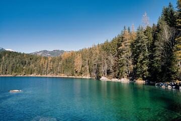 Eibsee - beautiful blue green lake in the mountains with forest in the background
