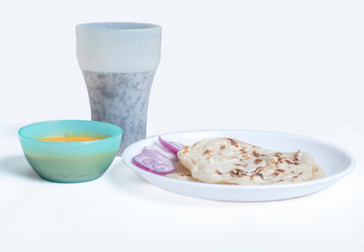 Kerala parotta with chicken curry and coke (cool drinks ) isolated on a white background. is a delicacy from the state of Kerala