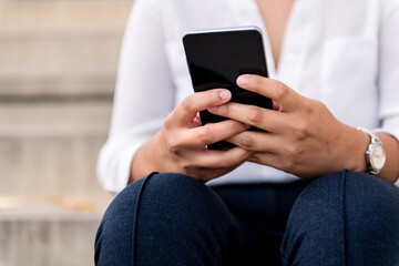 hands of a businesswoman holding a smart phone