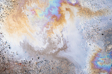 beautiful iridescent stains of gasoline or oil in a puddle