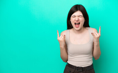 Fototapeta premium Young Russian woman isolated on green background making horn gesture
