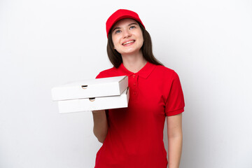 Young Russian pizza delivery picking up pizza boxes isolated on white background thinking an idea...