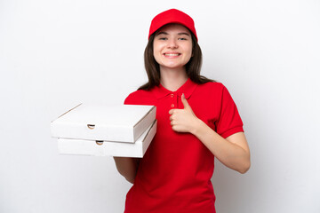 Young Russian pizza delivery picking up pizza boxes isolated on white background giving a thumbs up...