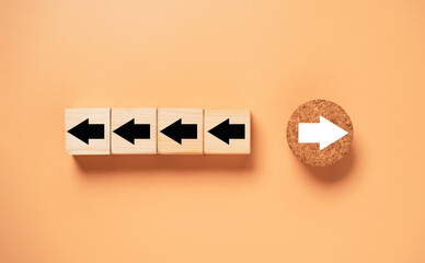 White arrow on circle wooden move on different direction with black arrow on cube for business and...