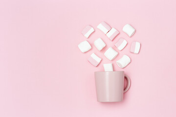 Romance holiday concept, pink mug or cup and marshmallows in shape of heart, declaration of love