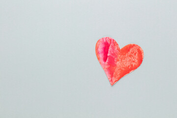 Cut the heart shaped paper, put on a pastel background.