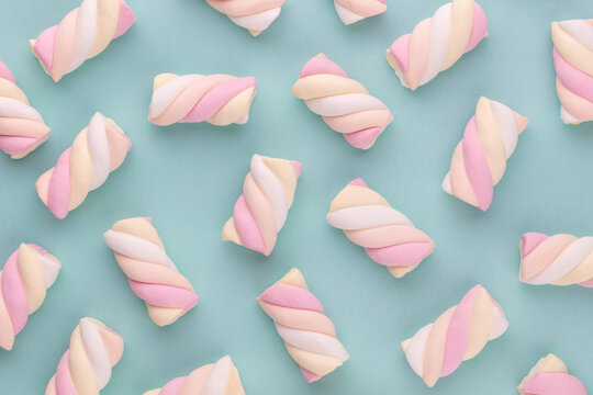 Colorful marshmallow laid out on pastel background. Creative textured pattern.