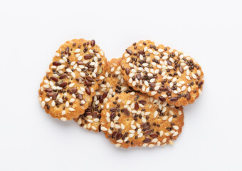 Tasty crackers with seeds on the white background.
