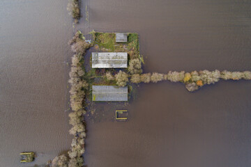 Aerial view of a farm between fields flooded by storms in Ourense, Spain