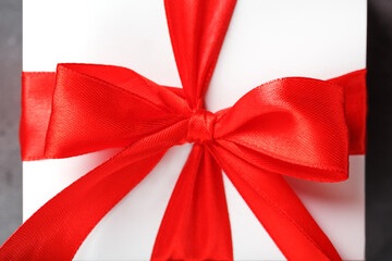 Red bow on a gift made of fabric on a white background