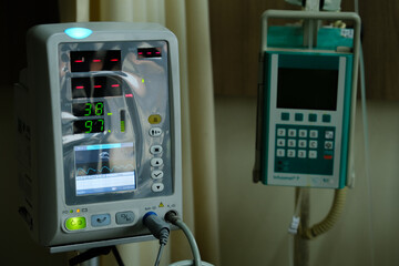 Selective focus picture with noise effect added of vital sign monitor used in a paediatric ward.