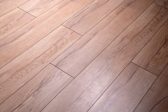 brown parquet board with rough texture and illumination.