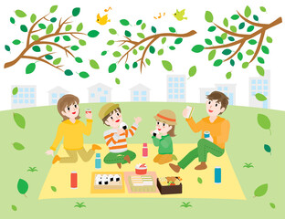 Obraz na płótnie Canvas ピクニックでお弁当を食べる家族