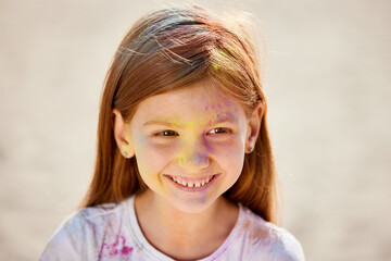 Fototapeta premium Portrait of happy little child girl in holly paints