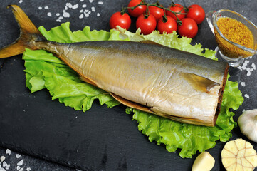 Appetizing smoked fish on kitchen board.Smoked mackerel.Smoked fish with spices