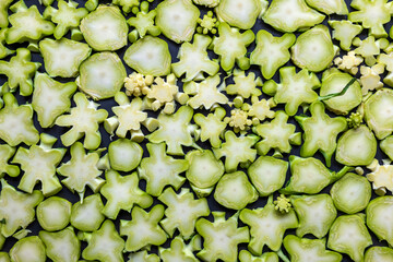 Fresh green broccoli stalk slices closup background
