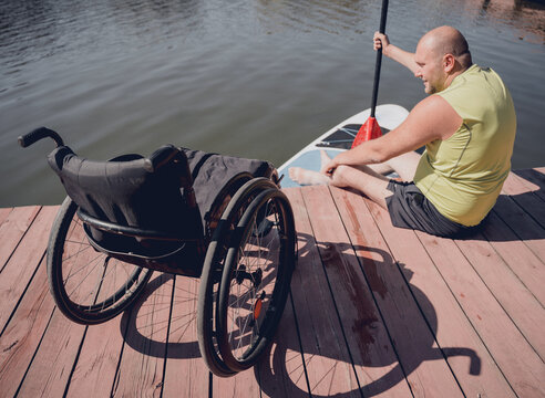 Person with a physical disability who uses wheelchair will be ride on sup board