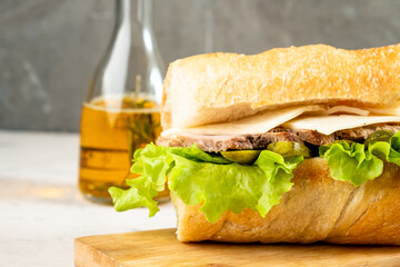 Homemade Cuban sandwich close-up on a light table.