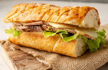 Classic cubano sandwich with pork, cheese and pickled cucumbers. Cuban sandwich. Close-up. Selective focus.