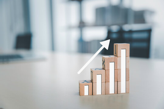 Business sale performance growth concept, Wooden cube box with graph and rising arrow, Progress improvement concept