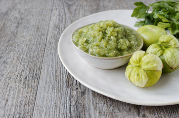 Fresh tomatillo green salsa (salsa verde cruda) in a bowl. Typical Mexican cuisine.