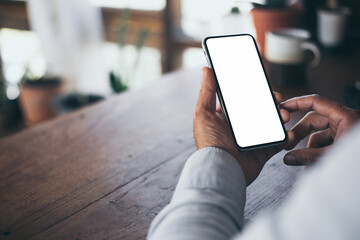 cell phone blank white screen mockup.hand holding texting using mobile on desk at office.background empty space for advertise.work people contact marketing business,technology