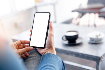 cell phone blank white screen mockup.hand holding texting using mobile on desk at office.background empty space for advertise.work people contact marketing business,technology