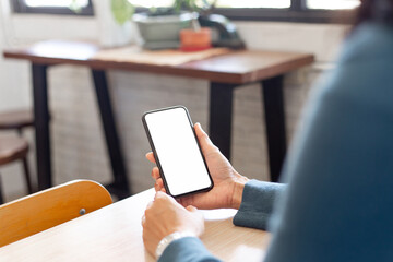 cell phone blank white screen mockup.hand holding texting using mobile on desk at office.background empty space for advertise.work people contact marketing business,technology