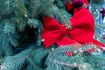 Selective shot of decorations, toys and lights on decorated christmas tree. Selective focus. Blurred