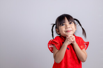 happy Chinese new year. Little Asian girls with Congratulation gesture