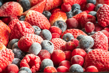frozen mix strawberries blueberries raspberries and cranberries closeup