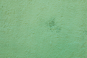 Old shabby plaster in light green pastel color.